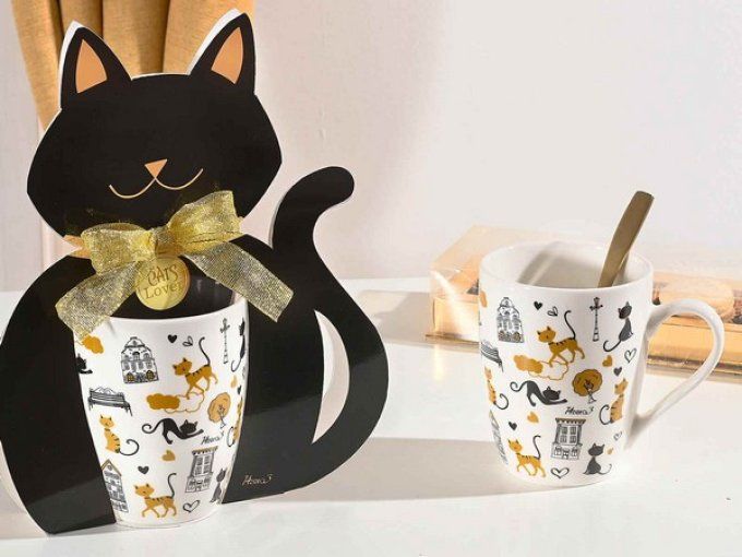 Tasse en porcelaine dans une boîte cadeau en forme de chat avec un noeud doré